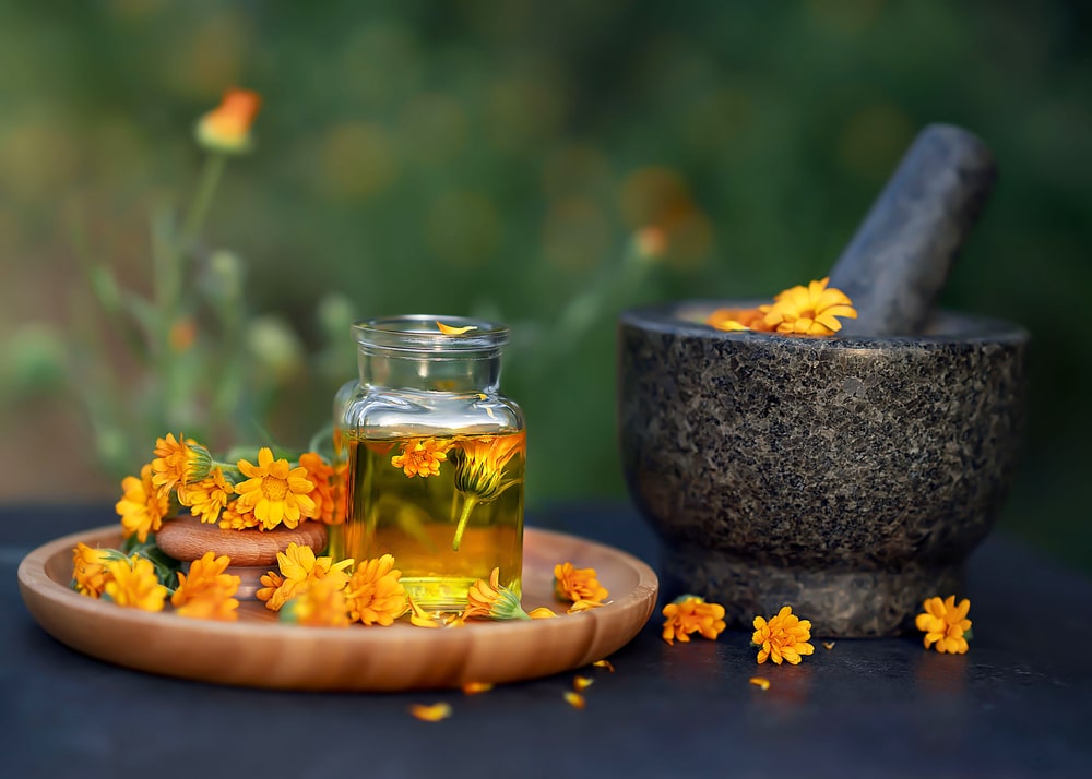 Glass,Bottle,Essential,Oil,Of,Calendula,And,Fresh,Calendula,Flowers