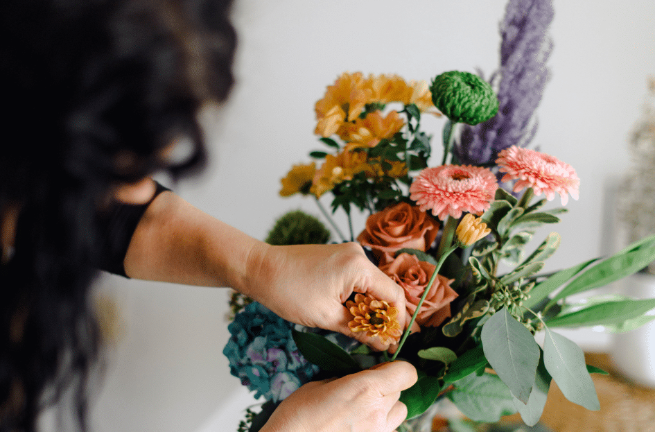 The Lavender House Flower Shop flower Delivery woman building beautiful flower arrangement for administrative professionals day